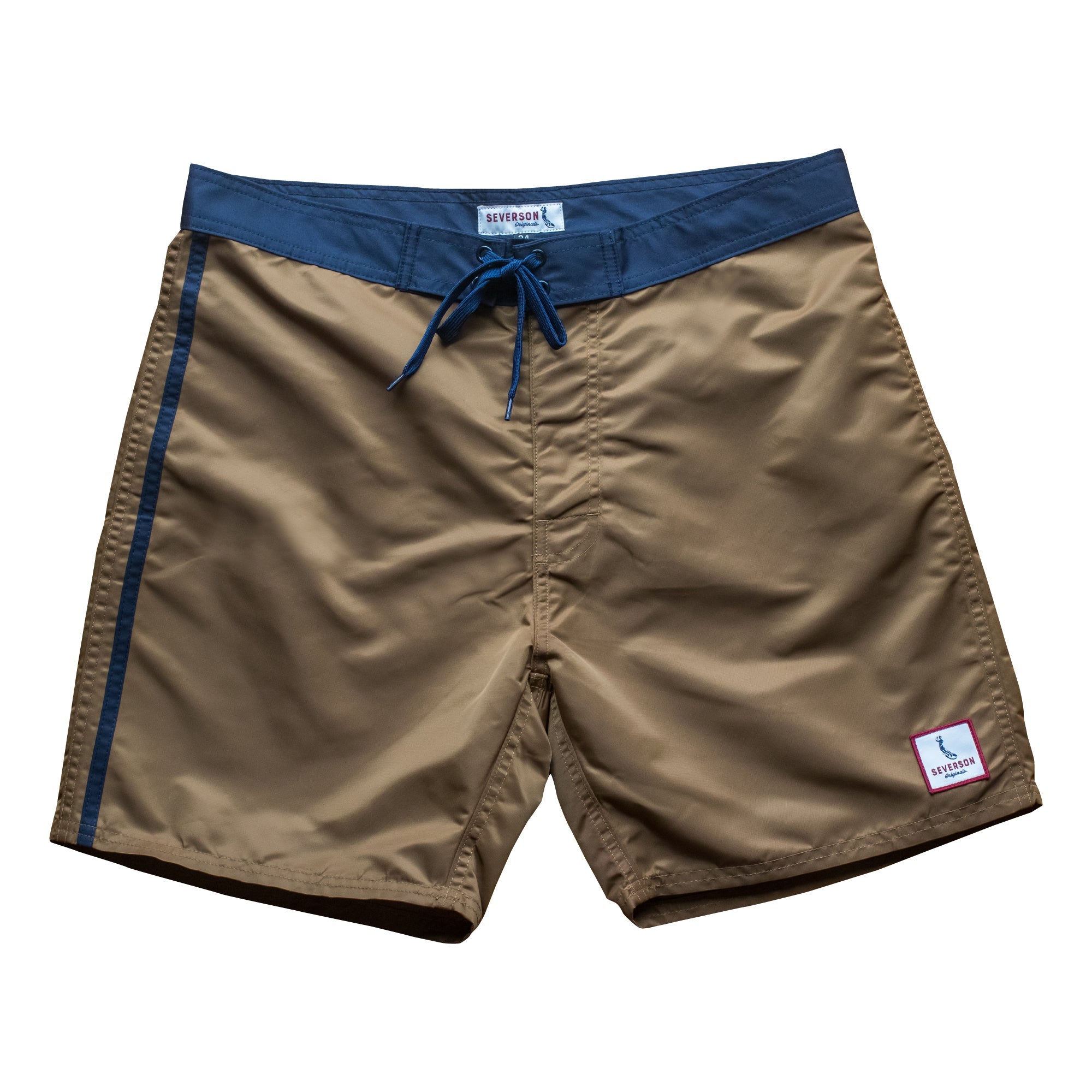Front view of vintage style surf trunks in coyote brown with navy trim and navy stripes on side. Material is a durable satin nylon. Severson square label on left corner.